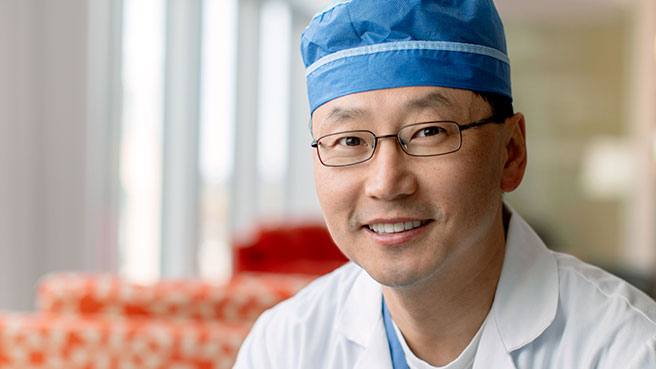 researcher and neurosurgeon Dr. Kendall Lee in his medical scrubs