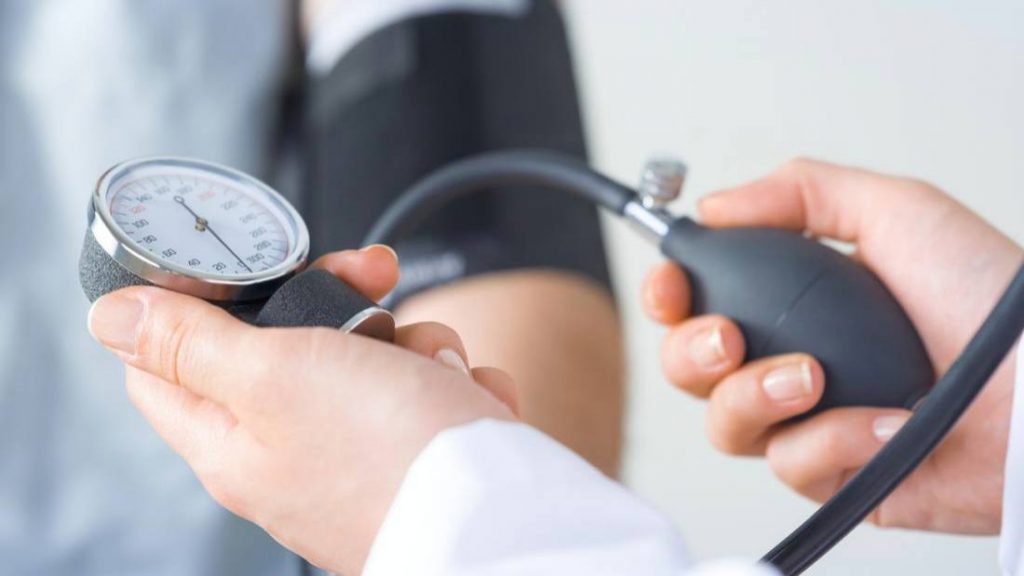 a person having their blood pressure checked by a medical person