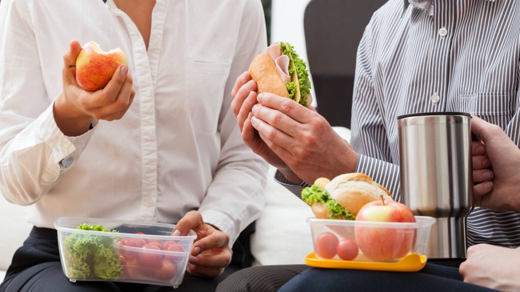 business people eating healthy lunch packed in home containers