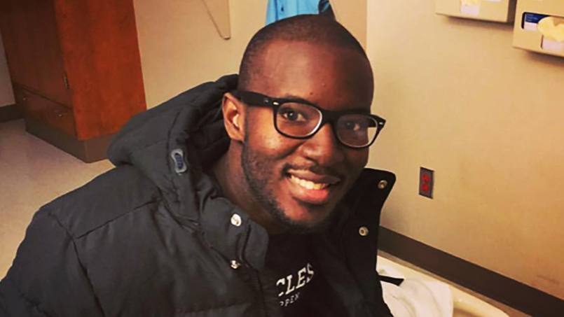 kidney transplant patient Jimmy Warren wearing glasses and smiling in a hospital room