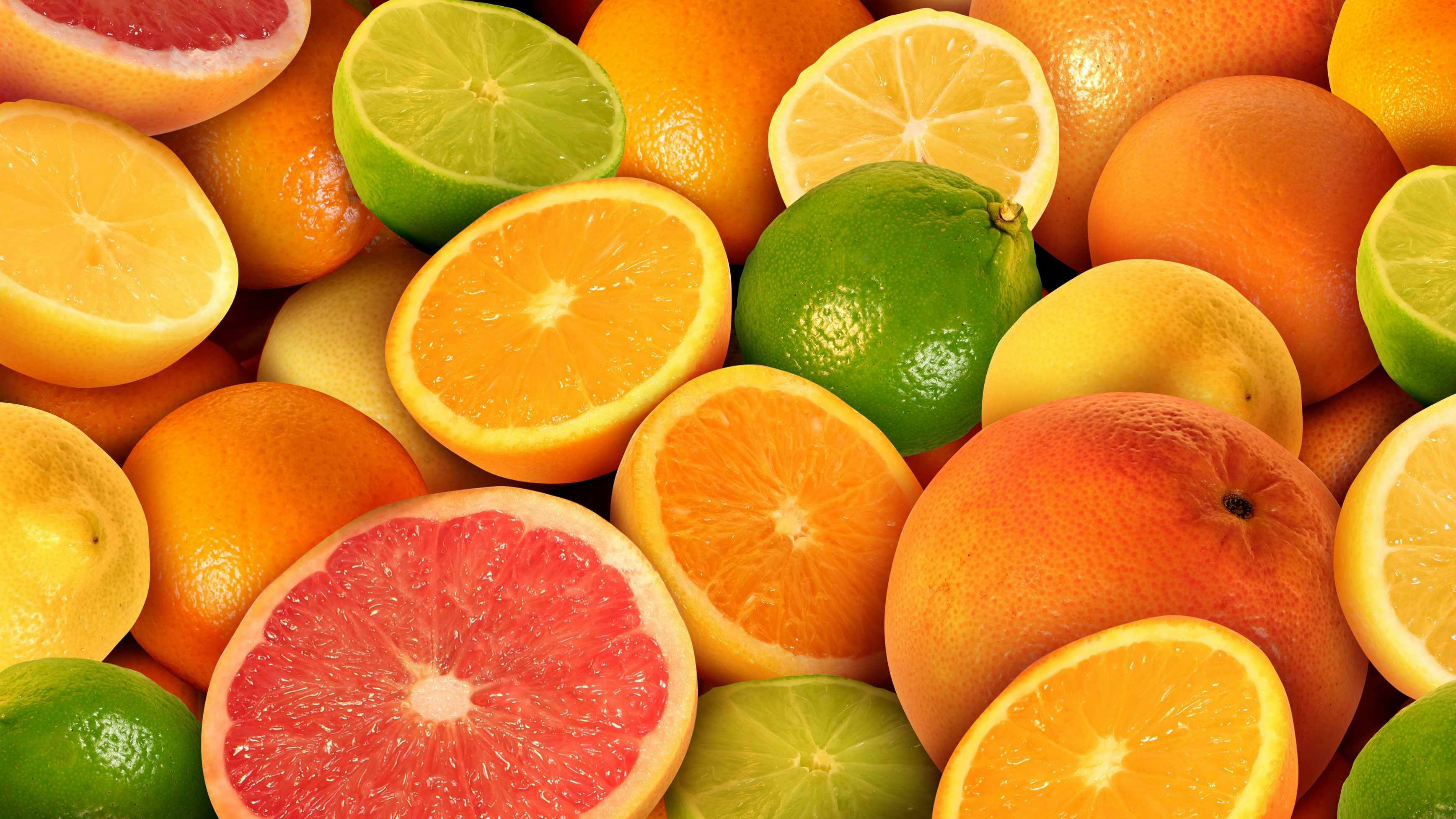 a pile of citrus fruits, oranges, lemons, limes and grapefruits 