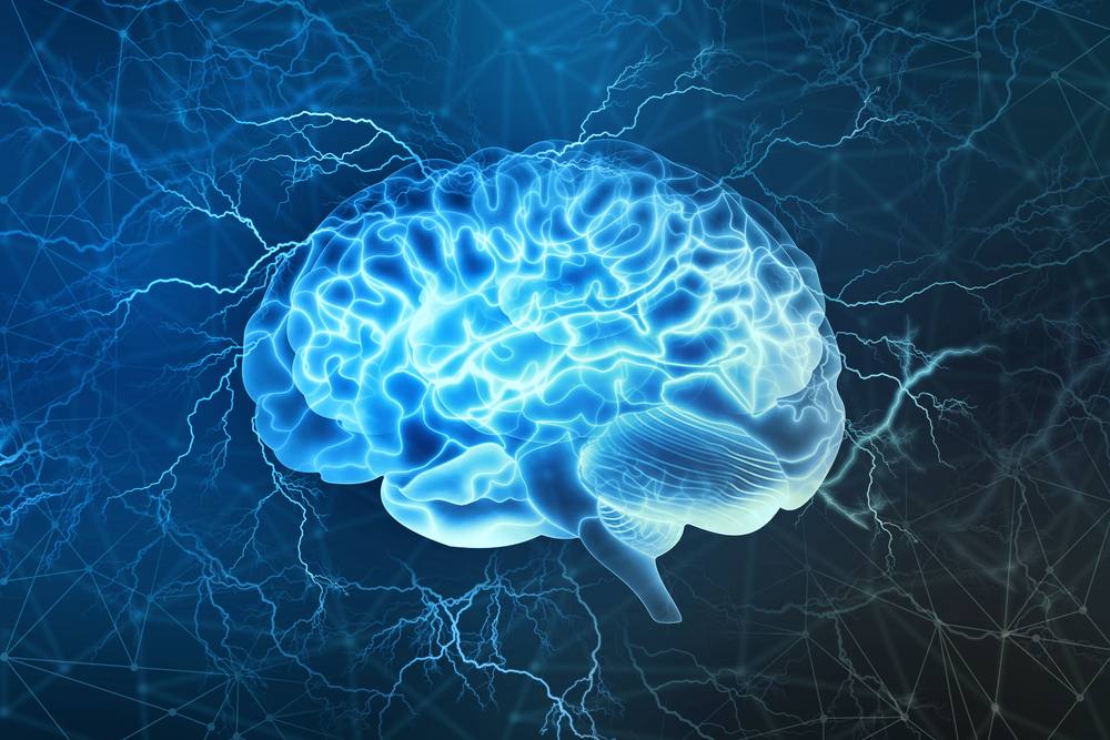Digital illustration of human brain with electrical activity in background
