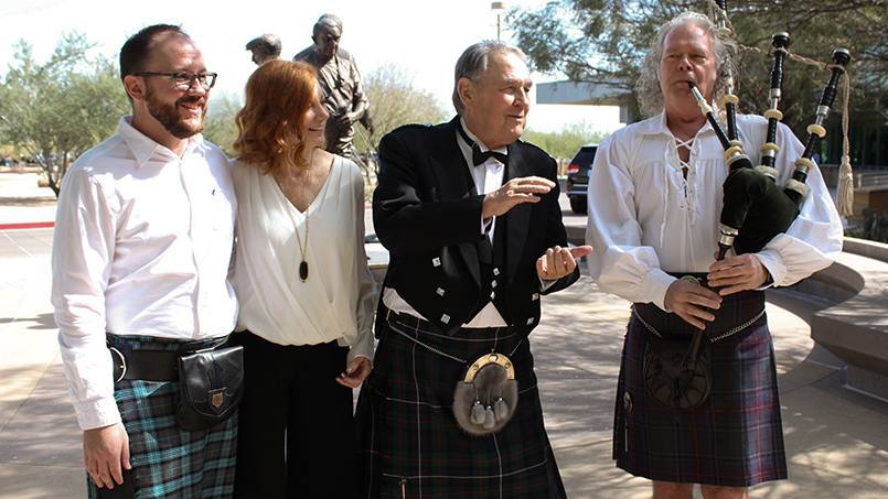 prostate cancer patient Doug Walsh in a kilt with family and a bagpiper