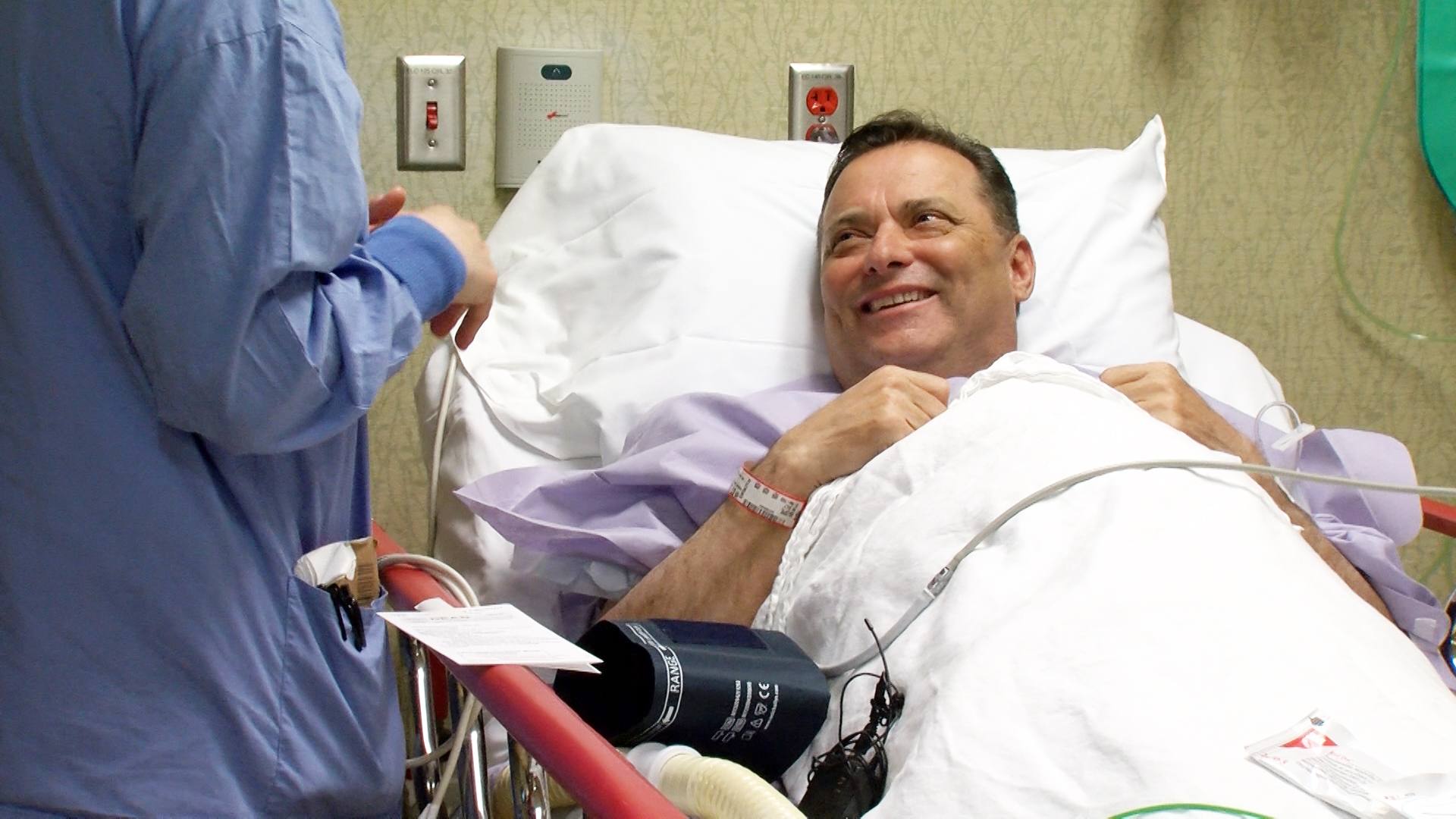 basketball coach Billy Gillispie in a hospital bed before  kidney transplant surgery