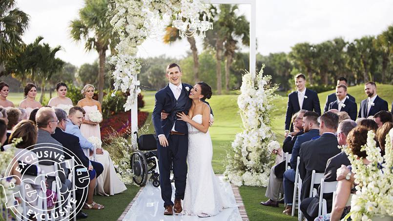 patient Chris Norton and his wife Emily walking down the aisle together at their wedding