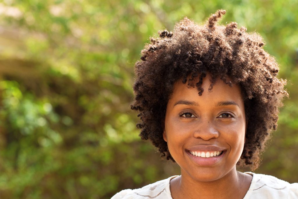 a happy young African American woman smiling