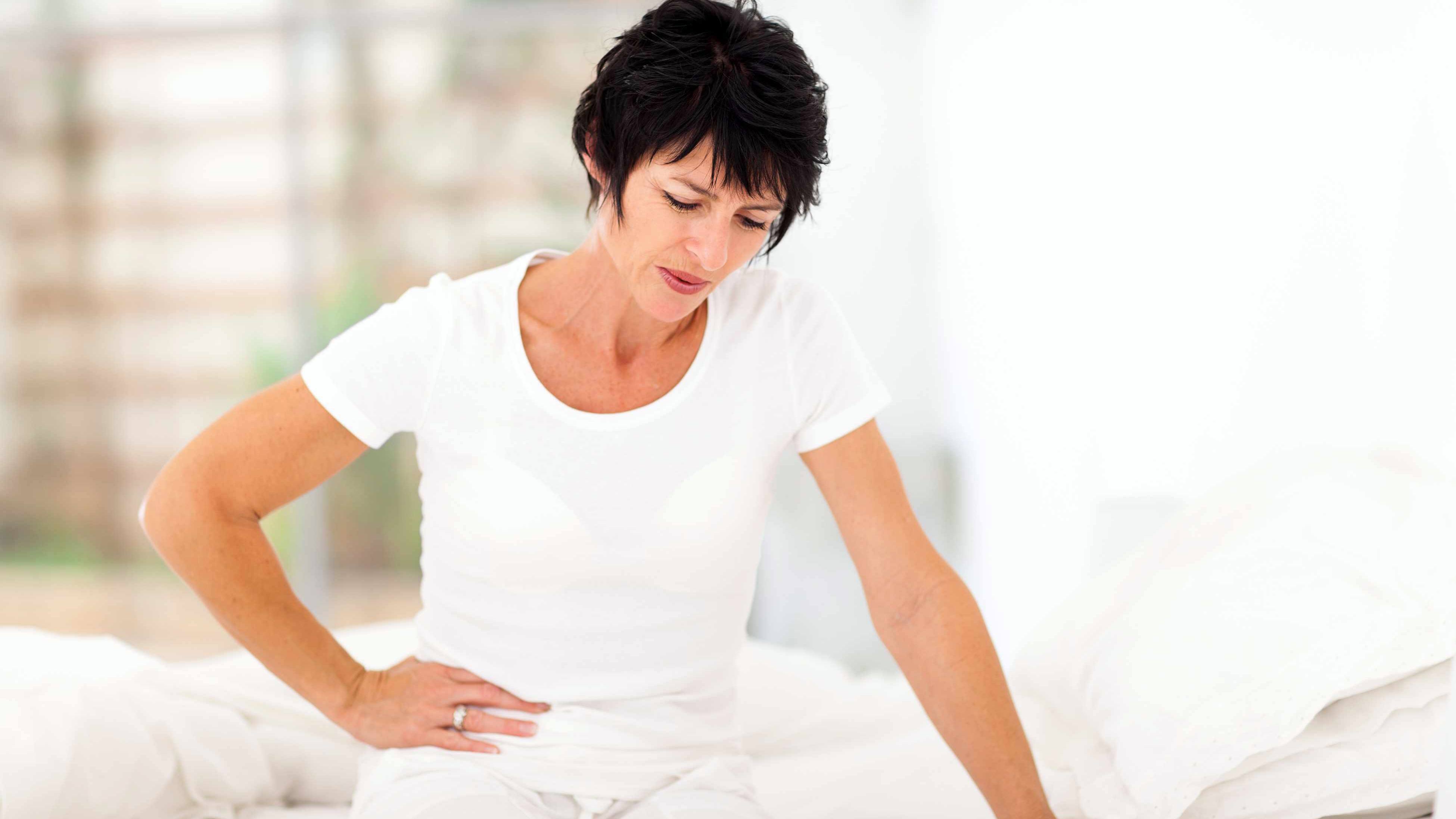 woman having stomach aches, cramps and pain - menstruation