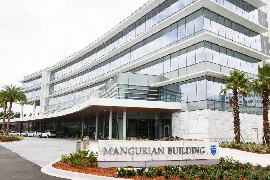a closeup of the Mangurian Building and sign on the Florida campus