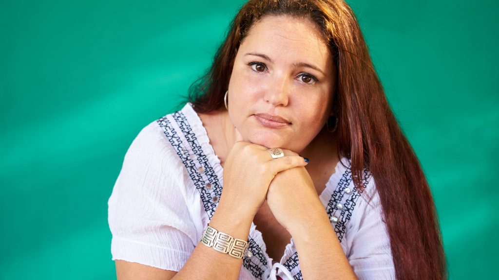 Portrait of sad overweight young woman looking at camera.