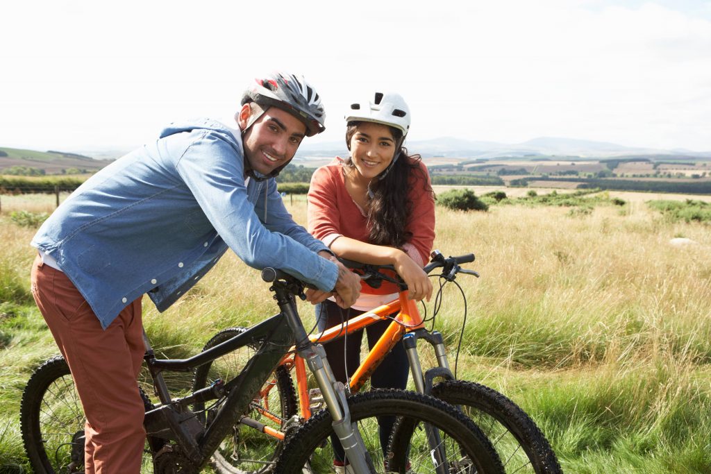 Young couple cycling In countryside