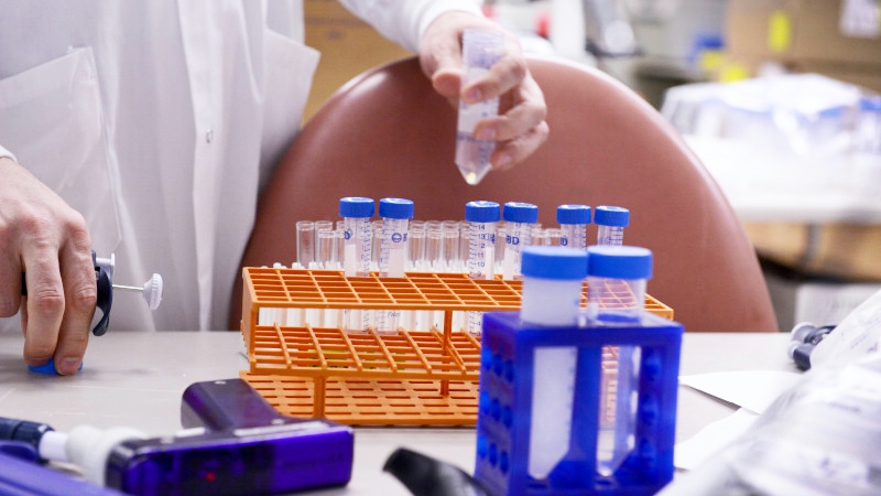 a research worker organizing test tubes in a Mayo Clinic vaccine research lab