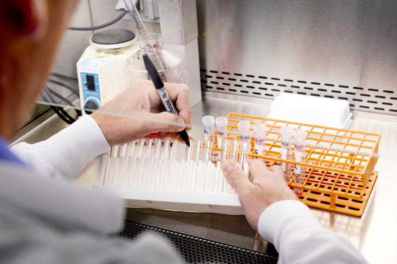 a research workers marking test tubes in a Mayo Clinic vaccine research lab