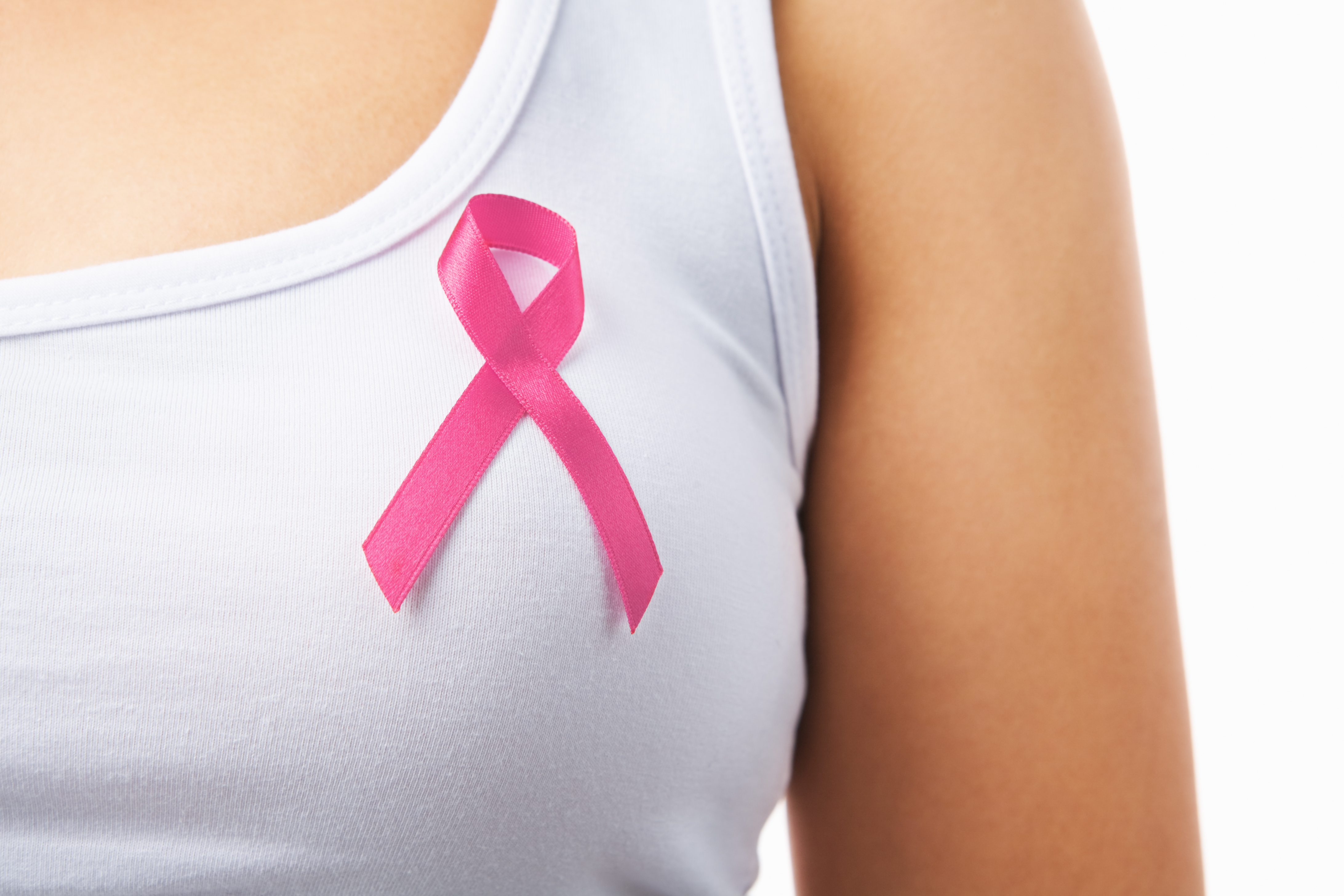 Close up of woman wearing a pink ribbon for breast cancer awareness