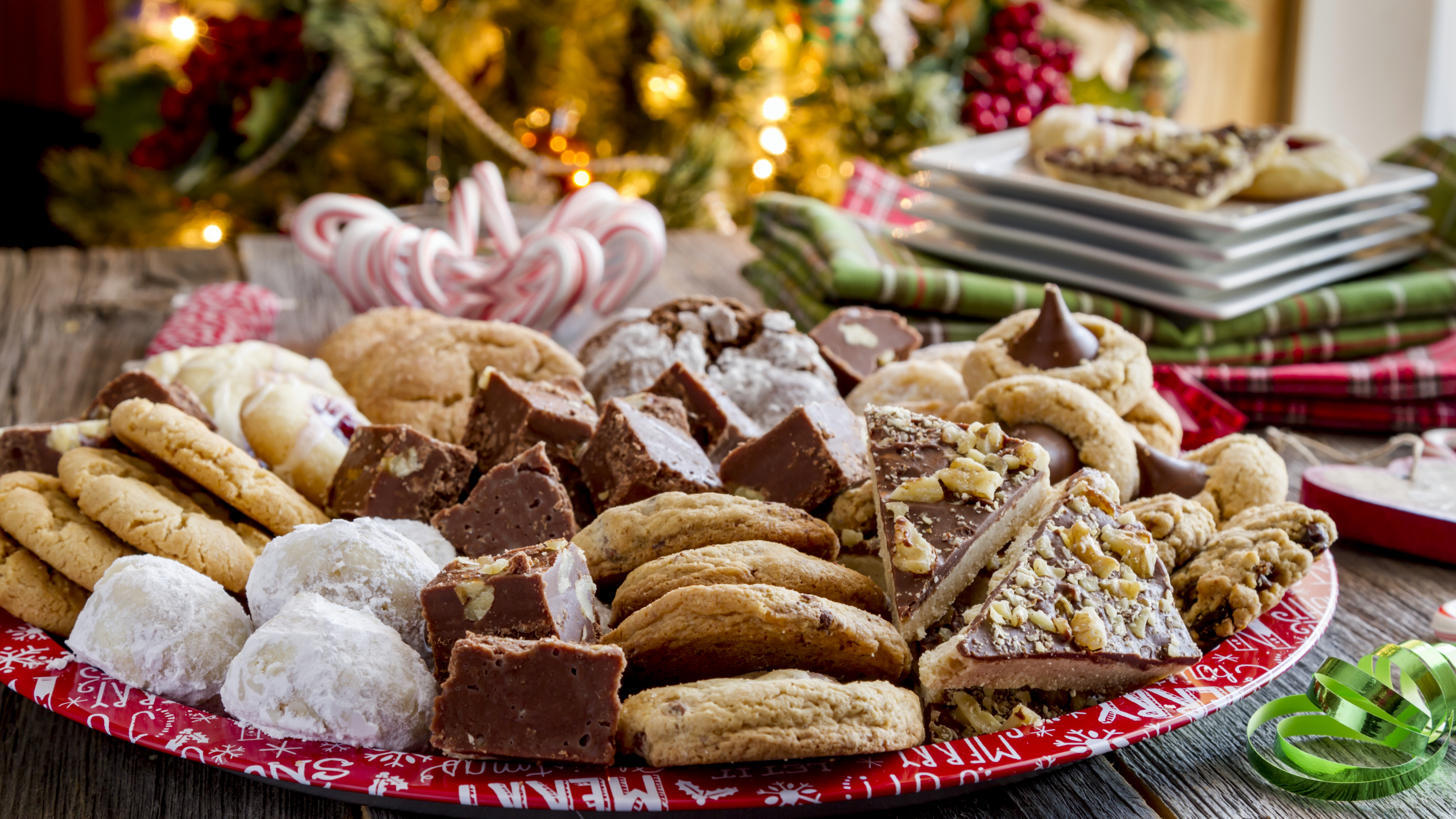 a large plate of sugar cookies and holiday treats for dessert