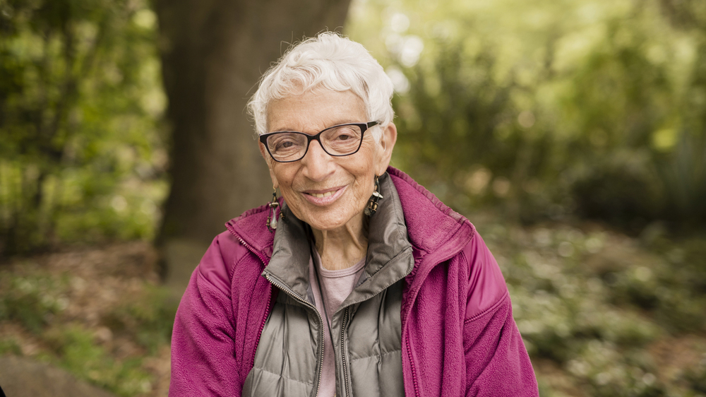 a smiling older woman outdoors
