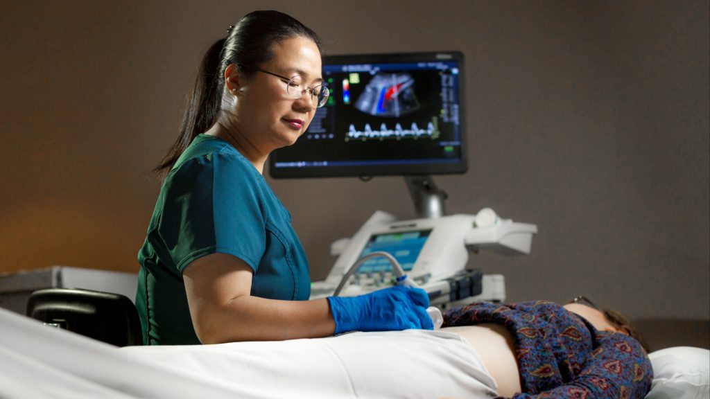 sonographer Wendy Liu in an exam room conducting an ultrasound