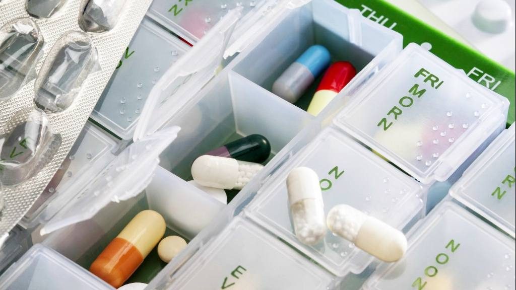 a pill box filled with prescription medicines