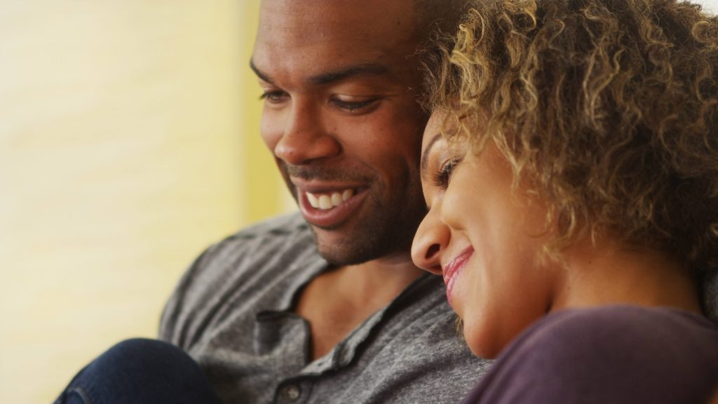 a close-up of a smiling young couple