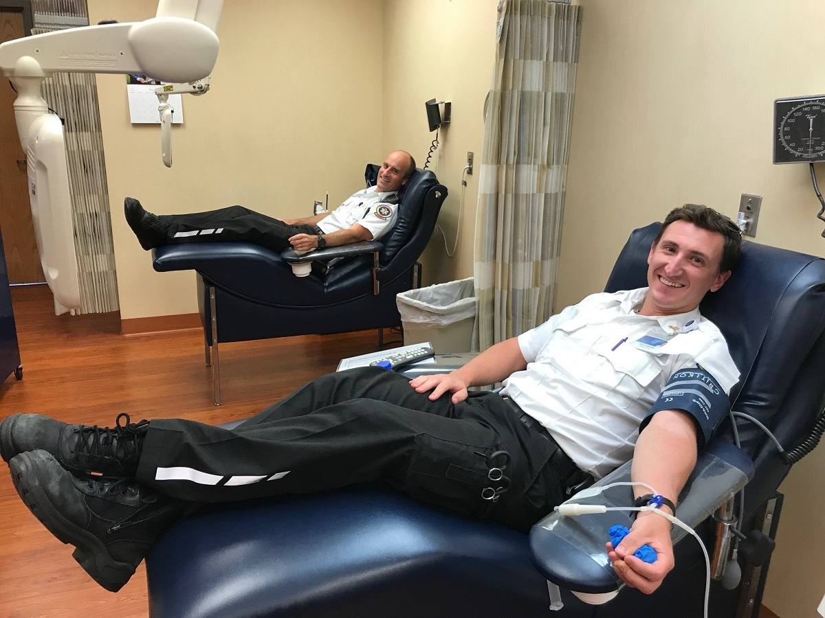 two Mayo Clinic Ambulance employees donating blood