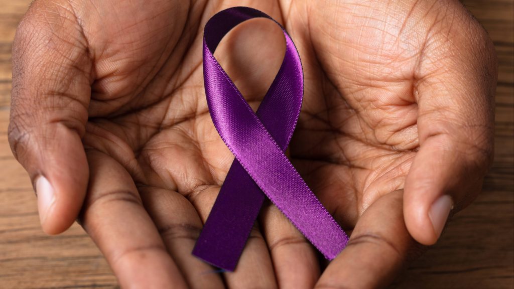 a person's hands cupped and holding a purple ribbon representing Alzheimer's disease, memory loss, dementia, cognitive function