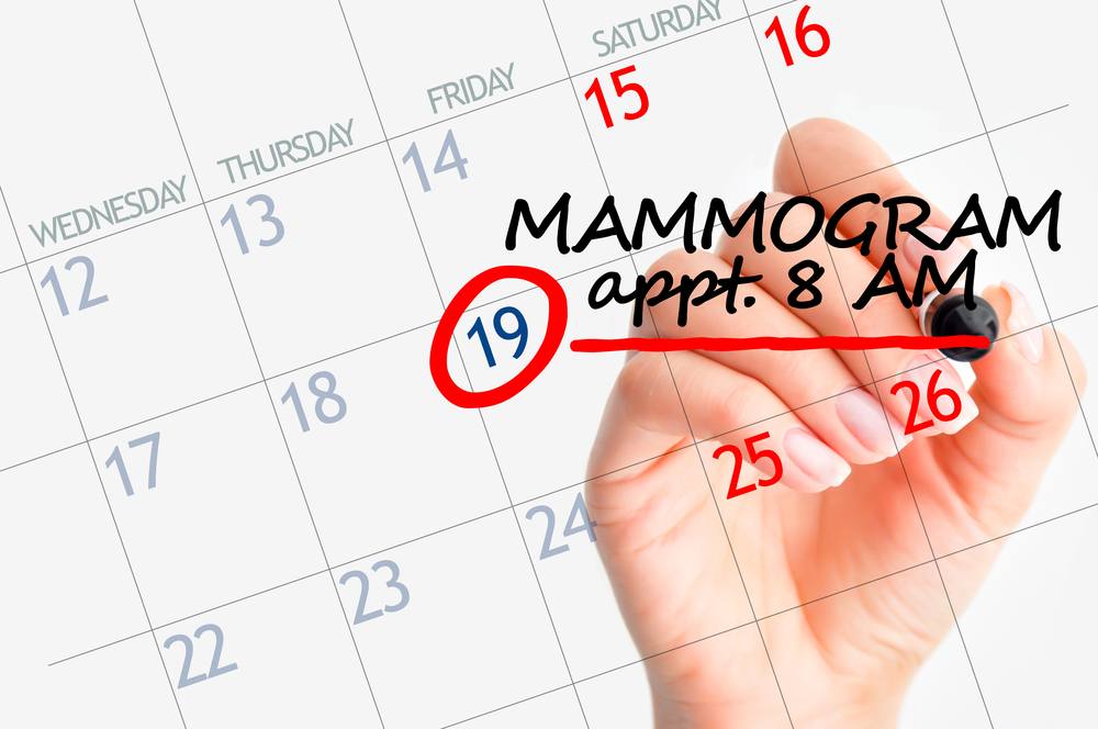 a calendar with a date circled and a hand writing MAMMOGRAM appt 8 AM