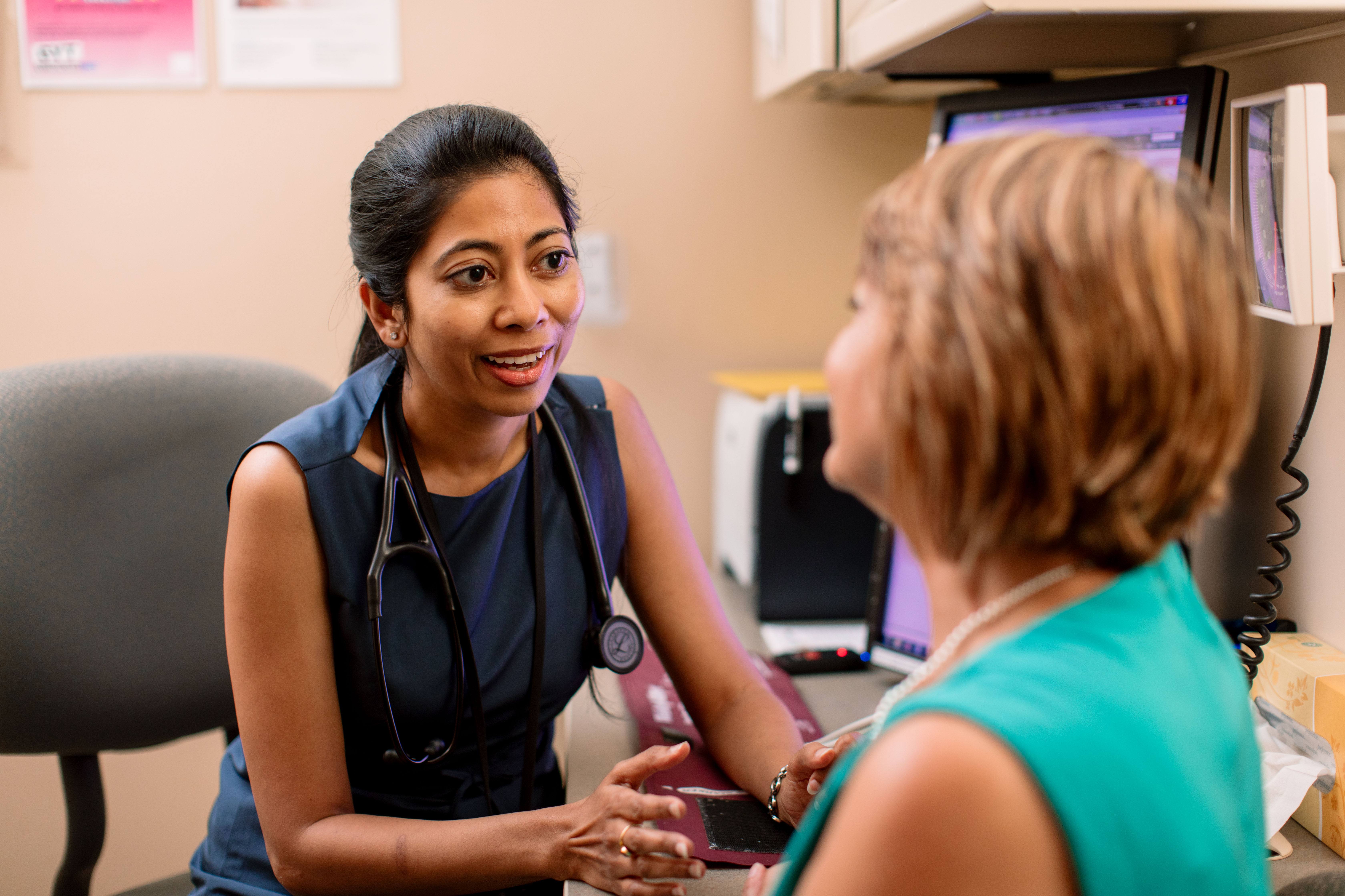 female health care provider speaks with female patient