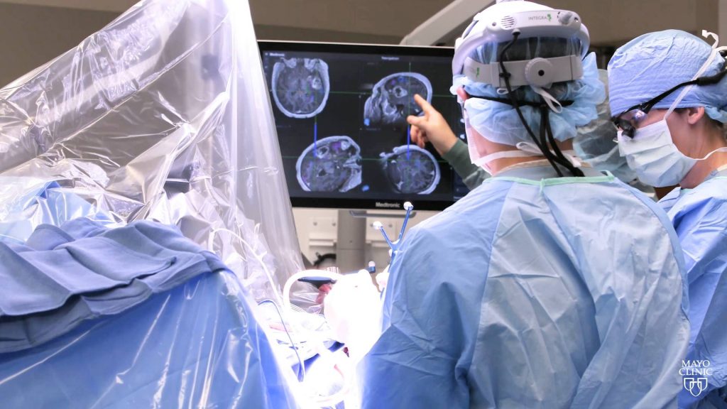 brain tumor surgery with surgeon's in the operating room looking a radiology Xray images of a person's head