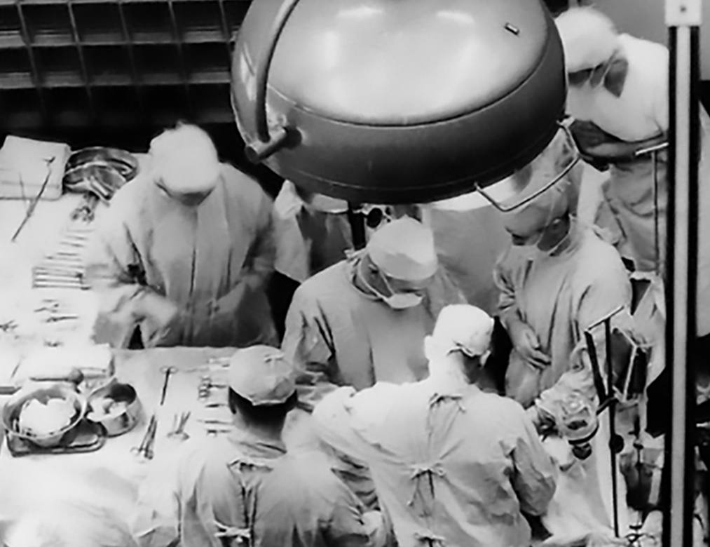 historical photo of surgeons performing a transplant surgery