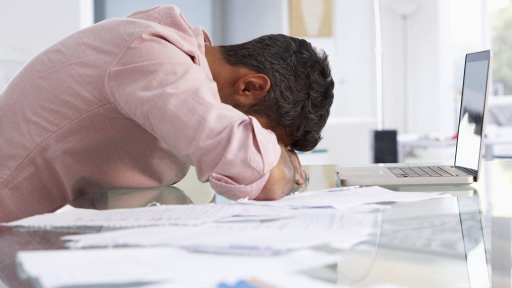 man with head down, depressed, despondent, sad, tired