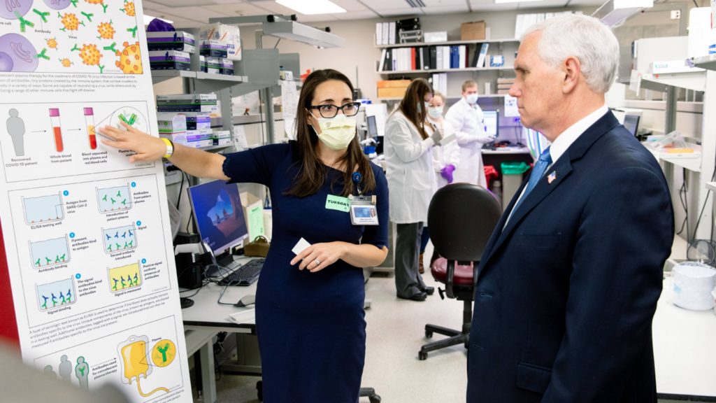 Vice President Pence in a Mayo Clinic lab with a researcher explaining convalescent plasma for COVID-19 testing