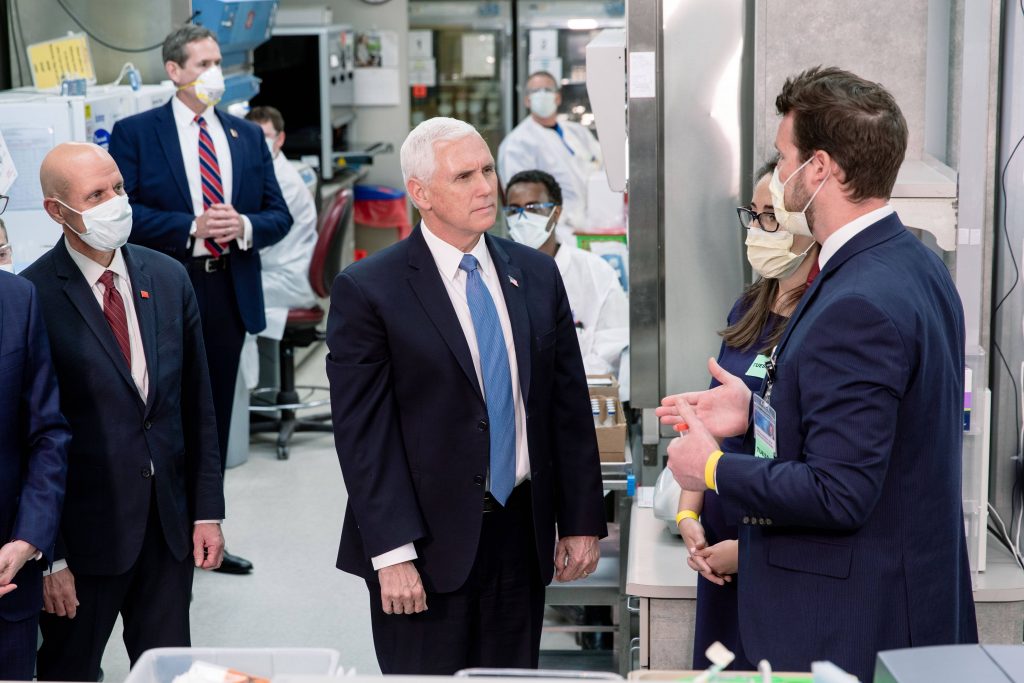 Vice President Pence listening to a researcher describe the lab work with COVID-19 testing
