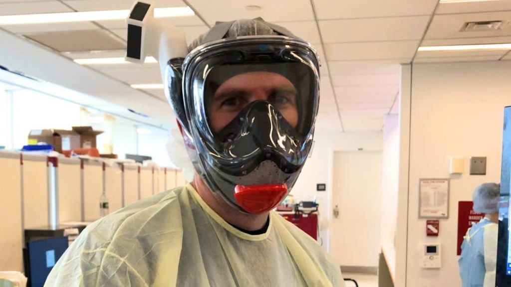 Mayo Clinic Intensivist Dr. Ben Daxon in a face shield and protective gear, working in a New York ICU to help COVID-19 patients