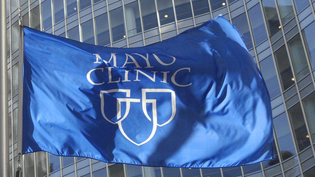 the Mayo Clinic blue and white flag with three shield image, flying outside the Gonda Building
