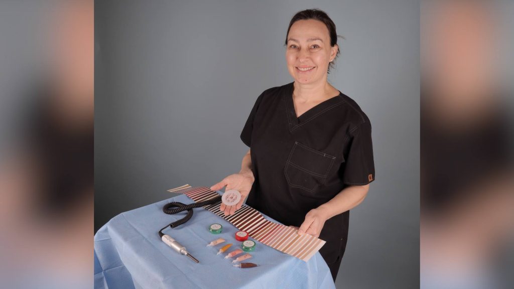 Dr. with her surgical tray, her tattoo needle machine and different colored paints
