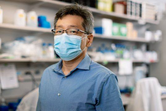 Wearing a facemask in the laboratory, Hideki Ebihara, Ph.D., a Mayo Clinic virologist who leads Mayo's Emerging Virus Program.
