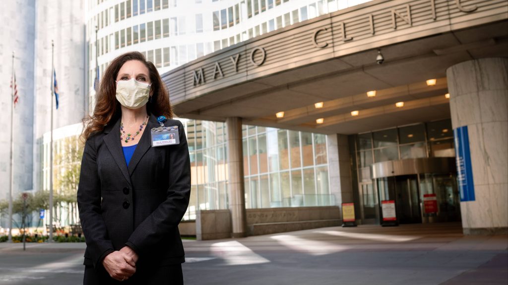 Amy W. Williams, M.D. Executive Dean for Practice Mayo Clinic standing outside the Gonda Building wearing a face mask