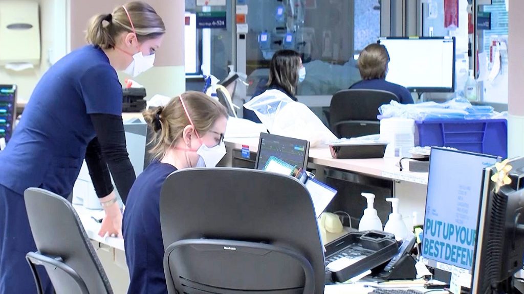 Mayo Clinic medical staff on the ICU floor, working on computer monitors and wearing facemasks