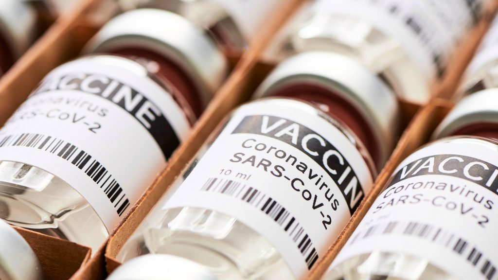 several laboratory vials labeled COVID-19 Coronavirus SARS-CoV-2 Vaccine in a delivery box
