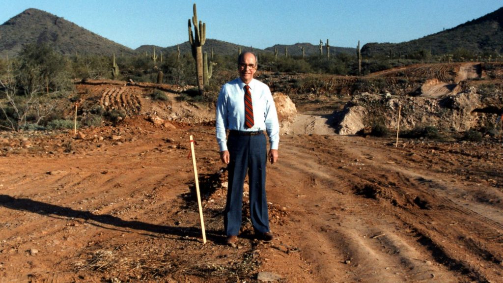 Richard Hill, M.D., standing with a shovel on the site of the future Mayo Clinic campus