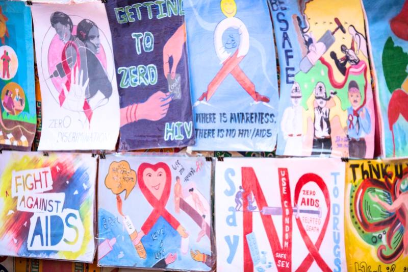 a quilt with drawings and pictures remembering those who died of AIDS