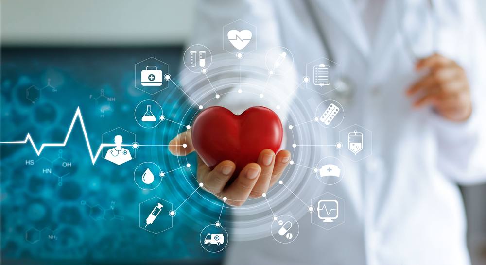 Medical person holding red heart model and futuristic icon medical network connection with virtual screen