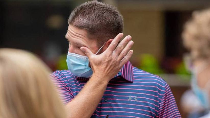 Mayo Clinic cardiaology patient Jay Ryan wearing a mask and wiping tears from his eyes
