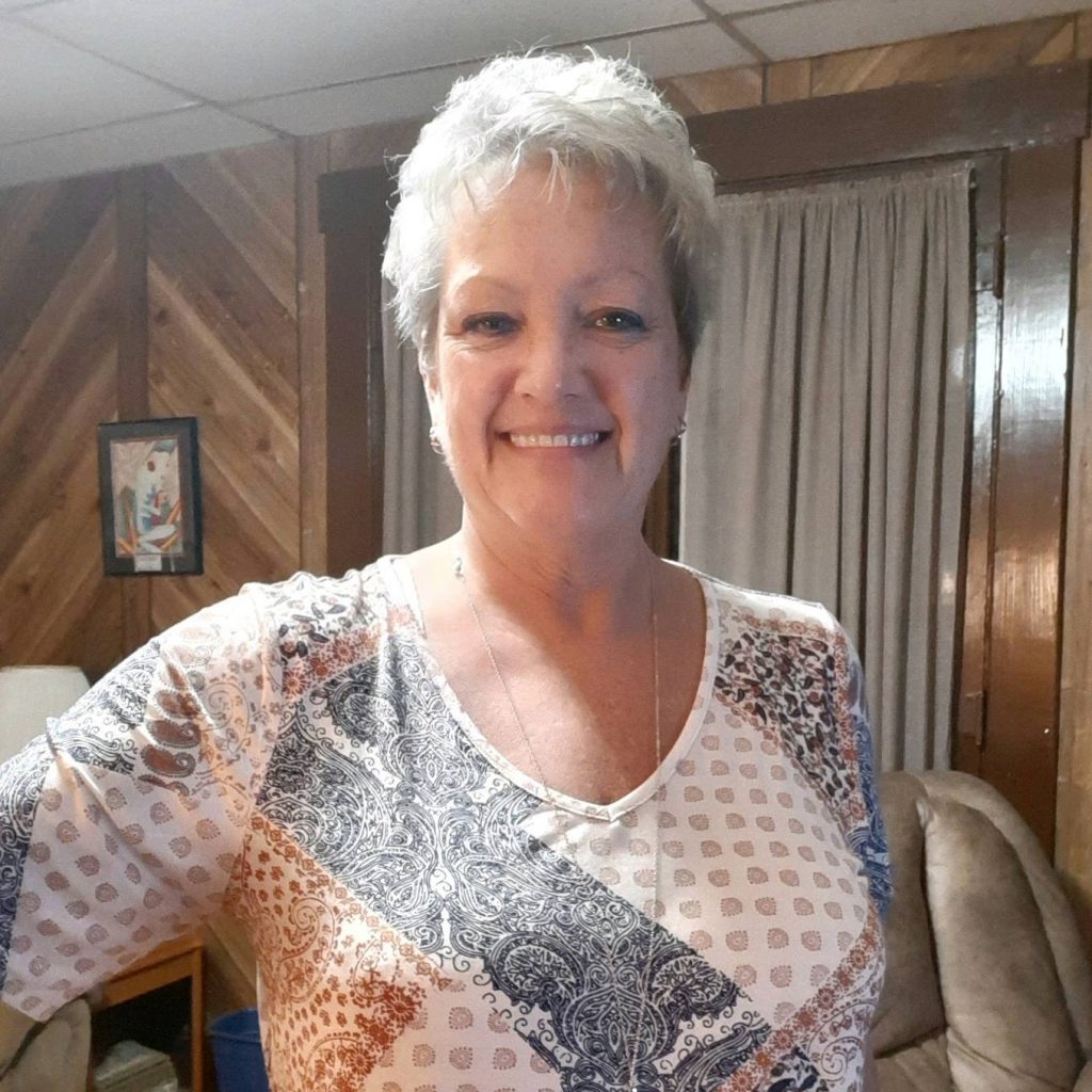 Lorinda McKinley, a patient with myasthenia gravis, smiling in her living room