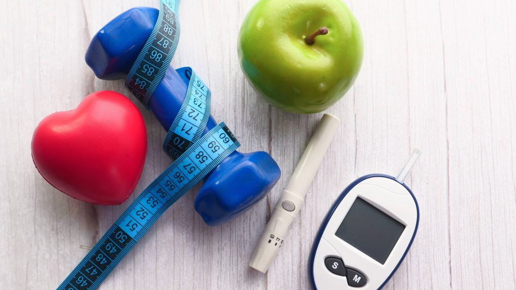 Blood Sugar Measurement Kits, Dumbbell and Apple On Table