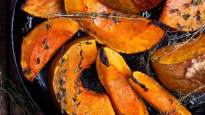 roasted sweet potatoes with herbs in a pan