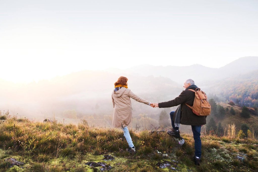 mature man and woman, hiking, foggy