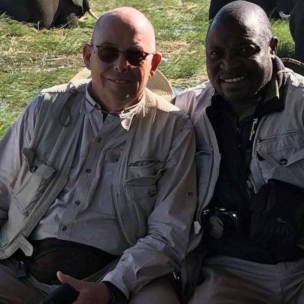 Kenneth Hobby (left) sits with Shadreck Sibwaalu in Botswana, Africa.