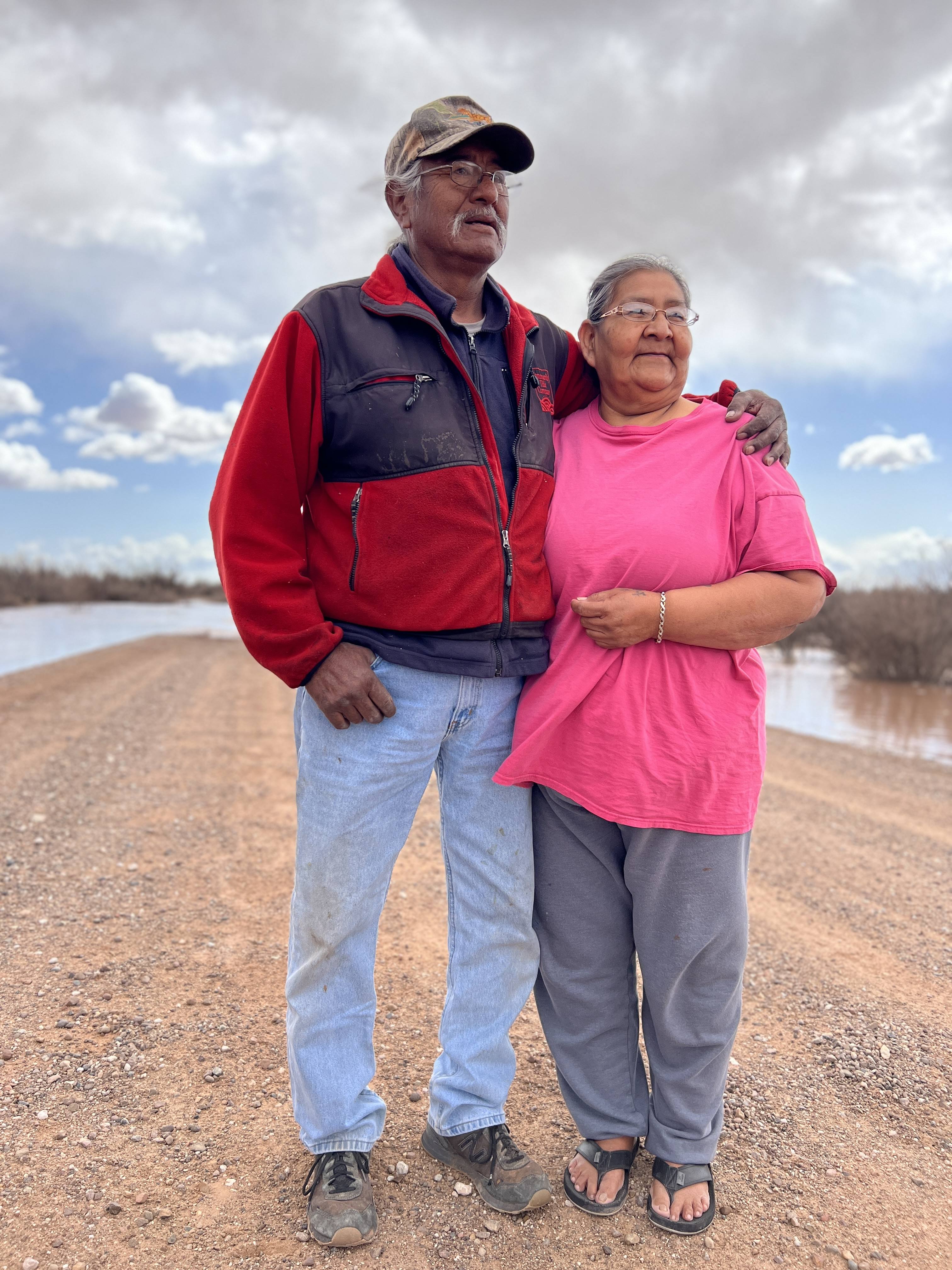 Robert Monroe and Jackie Johnson stand near their home on the Navajo Indian Reservation in Arizona