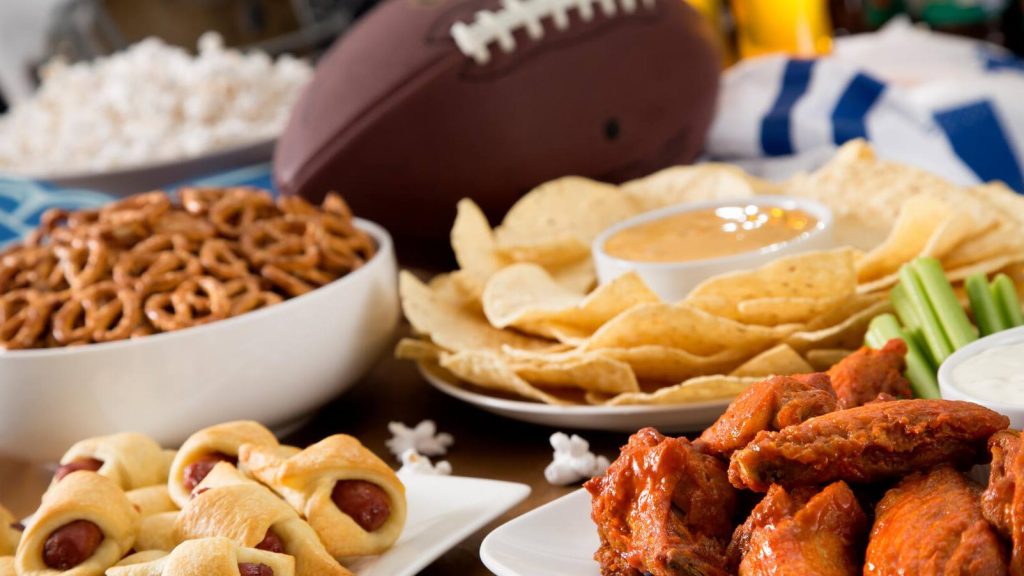 Football game snacks, chicken wings, chips, pretzels, 