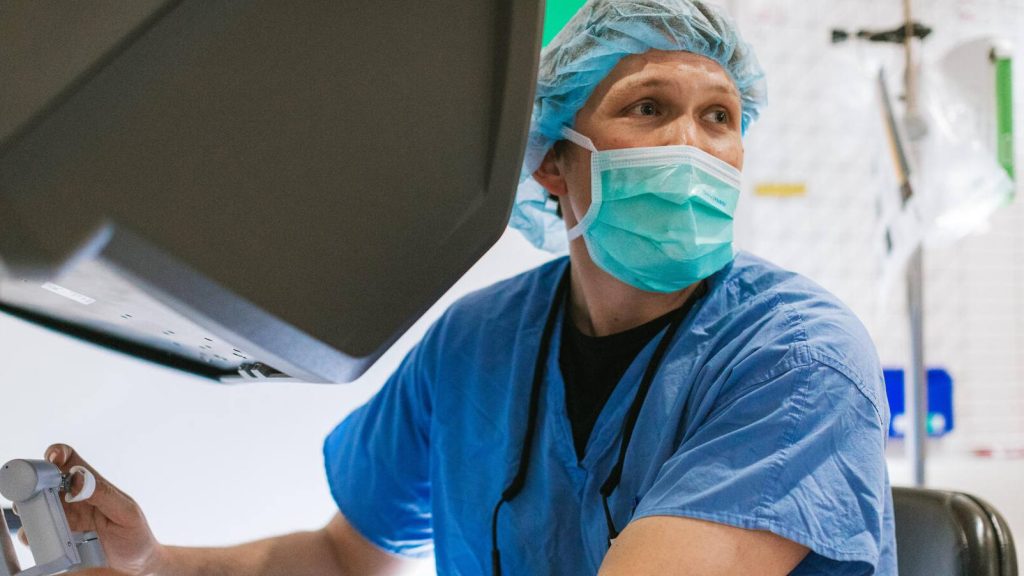 Dr. Aaron Potretzke performing robotic-assisted surgery